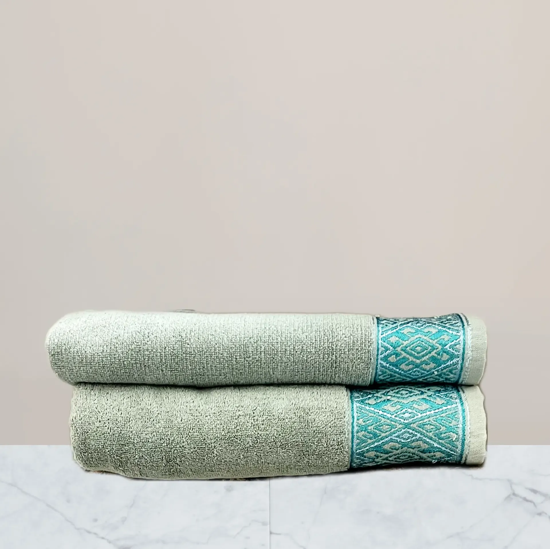 a stack of towels on a marble surface green towel 600 gsm towel